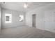 Bedroom with neutral carpet, ceiling fan, walk-in closet, and white doors at 120 Central Townes Way # 292, Raleigh, NC 27603