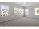 Bright bedroom featuring multiple windows for ample natural light and neutral carpeting at 120 Central Townes Way # 292, Raleigh, NC 27603
