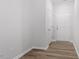Clean, bright entryway featuring wood-look flooring, white walls, and a closet, offering a welcoming first impression at 120 Central Townes Way # 292, Raleigh, NC 27603