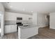 Well-lit kitchen featuring white cabinets, granite countertops, and wood-look flooring, blending style and functionality at 120 Central Townes Way # 292, Raleigh, NC 27603