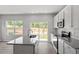 Bright kitchen boasts white cabinetry, granite countertops, a center island, and stainless steel appliances at 120 Central Townes Way # 292, Raleigh, NC 27603