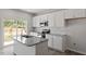 Well-lit kitchen features granite countertops, stainless appliances, tile backsplash, and center island at 120 Central Townes Way # 292, Raleigh, NC 27603