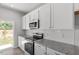 Updated kitchen with granite countertops, stainless appliances, white subway tile backsplash, and backyard access at 120 Central Townes Way # 292, Raleigh, NC 27603