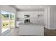 Modern kitchen featuring white cabinets, granite countertops, stainless appliances, and access to the backyard at 120 Central Townes Way # 292, Raleigh, NC 27603