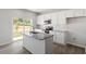 Modern kitchen with white cabinets, granite countertops, and stainless steel appliances, offering a stylish cooking space at 120 Central Townes Way # 292, Raleigh, NC 27603