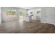 Open-concept kitchen featuring white cabinets, granite countertops, and wood-look flooring, perfect for entertaining at 120 Central Townes Way # 292, Raleigh, NC 27603