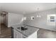 Bright kitchen island with granite countertops, stainless steel sink and dishwasher, and hardwood flooring at 120 Central Townes Way # 292, Raleigh, NC 27603