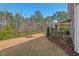 Spacious backyard with patio, outdoor seating, landscaping, fencing, and mature trees for privacy at 126 Filigree Way, Durham, NC 27713