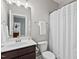 Neat bathroom with a white shower curtain, dark wood vanity, and neutral walls at 126 Filigree Way, Durham, NC 27713