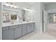 Elegant bathroom boasts double vanity, marble countertops, and modern lighting fixtures at 126 Filigree Way, Durham, NC 27713