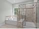 Bright bathroom features a soaking tub and a glass shower at 126 Filigree Way, Durham, NC 27713