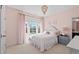 Cozy bedroom featuring a plush bed, soft lighting, and large windows with outside views at 126 Filigree Way, Durham, NC 27713