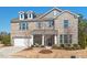 Beautiful two-story brick home with dormers, shutters and a two car garage at 126 Filigree Way, Durham, NC 27713