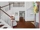 Elegant foyer boasts hardwood floors, a staircase, and open access to other rooms at 126 Filigree Way, Durham, NC 27713