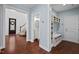 Hallway view with a powder room, mud room, hardwood floors, and staircase at 126 Filigree Way, Durham, NC 27713