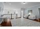 Upstairs hallway features hardwood floors, white chair rail molding, and seating area at 126 Filigree Way, Durham, NC 27713