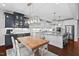 Spacious kitchen with a large center island, stainless steel appliances, and adjacent dining area at 126 Filigree Way, Durham, NC 27713