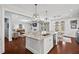 Modern kitchen island with stainless steel appliances and a seamless flow to dining and living areas at 126 Filigree Way, Durham, NC 27713