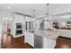 Open kitchen with stainless steel appliances and a view of the living room and dining area at 126 Filigree Way, Durham, NC 27713