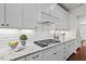 The kitchen features sleek white cabinets, granite countertops, and stainless steel appliances at 126 Filigree Way, Durham, NC 27713