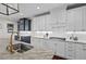 Bright kitchen boasts granite counters, white cabinets, and stainless steel appliances at 126 Filigree Way, Durham, NC 27713