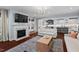 Bright living room with a fireplace and large TV, flowing into the kitchen and dining areas at 126 Filigree Way, Durham, NC 27713