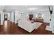 Open-concept living room features hardwood floors and neutral decor, with a view into the entry at 126 Filigree Way, Durham, NC 27713