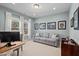 Bright living room with neutral walls, carpet, a comfortable couch and lots of natural light at 126 Filigree Way, Durham, NC 27713