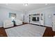 Bright living room features hardwood floors, TV, built-in bookshelves, and comfortable seating at 126 Filigree Way, Durham, NC 27713