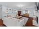 Cozy living room with neutral furniture, hardwood floors, a fireplace, and a large TV at 126 Filigree Way, Durham, NC 27713