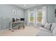 Inviting office space with light blue walls and neutral carpet, featuring a desk and a large window at 126 Filigree Way, Durham, NC 27713
