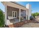 Covered outdoor patio features slate floors, porch swing, grill, seating, and a white fireplace at 126 Filigree Way, Durham, NC 27713