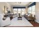 Inviting living room featuring bright windows, neutral furniture, and wood floors at 127 Gadwall Ln, Durham, NC 27703