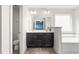 Bright bathroom featuring a double sink vanity, tile flooring, and a soaking tub at 130 Campaign Dr, Mebane, NC 27302