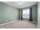 Serene bedroom featuring soft green walls, carpet flooring, and a bright window at 130 Campaign Dr, Mebane, NC 27302