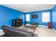 Bonus room featuring bright blue walls, a large television, comfortable seating, and a playful atmosphere at 130 Campaign Dr, Mebane, NC 27302