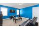 Bonus room features bright blue walls, a TV, and comfortable seating to unwind in at 130 Campaign Dr, Mebane, NC 27302