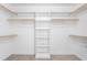 An organized closet with wood clothing racks and white shelving for optimal storage at 130 Campaign Dr, Mebane, NC 27302