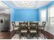 Bright dining room with a table, six chairs, and dark hardwood floors at 130 Campaign Dr, Mebane, NC 27302