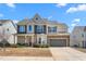Charming two-story home with stone accents and covered porch at 130 Campaign Dr, Mebane, NC 27302