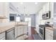 Bright kitchen featuring white cabinetry, granite countertops, and stainless steel appliances, ideal for cooking and entertaining at 130 Campaign Dr, Mebane, NC 27302