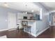 Modern kitchen featuring breakfast bar seating and an open design that flows into the living spaces at 130 Campaign Dr, Mebane, NC 27302