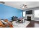 Bright living room with a fireplace, ceiling fan, and hardwood floors at 130 Campaign Dr, Mebane, NC 27302