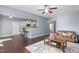 Inviting living room with warm brown leather sofa, stylish area rug, and seamless flow to the kitchen area at 130 Campaign Dr, Mebane, NC 27302