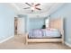 Spacious main bedroom featuring a tray ceiling, carpeted floors and a ceiling fan at 130 Campaign Dr, Mebane, NC 27302