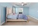 Spacious main bedroom with tray ceiling, ceiling fan, and soothing blue walls at 130 Campaign Dr, Mebane, NC 27302