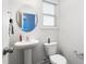 Cozy powder room with pedestal sink and natural light at 130 Campaign Dr, Mebane, NC 27302