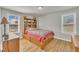 Comfortable bedroom featuring hardwood floors, natural light, and neutral paint at 130 Hardy Rd, Wendell, NC 27591