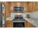 Well-equipped kitchen with stainless steel appliances including a microwave and a range at 130 Hardy Rd, Wendell, NC 27591