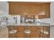 Modern kitchen boasts stainless steel appliances, light granite countertops, and bar stool seating at 130 Hardy Rd, Wendell, NC 27591